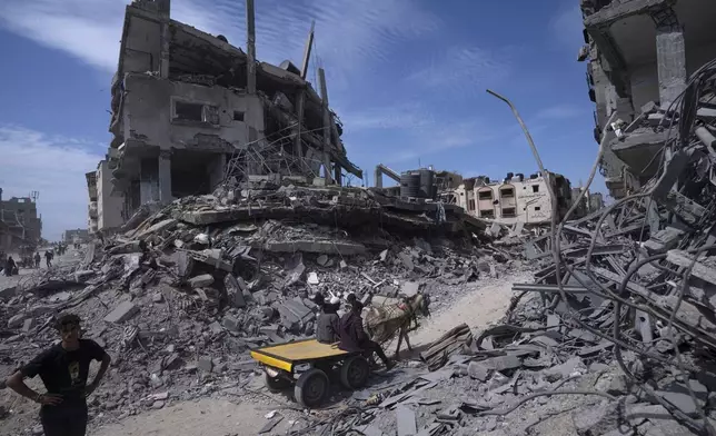 FILE - Palestinians salvage what they could from the destruction left by Israeli troops in Khan Younis, southern Gaza Strip, April 8, 2024. (AP Photo/Fatima Shbair, File)