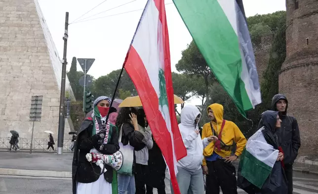 People stand during a protest in Rome, Saturday, Oct. 5, 2024. Pro-palestinians people take to the street in an unauthorised march in the centre of Rome two days ahead of the first anniversary of the Oct. 7. (AP Photo/Andrew Medichini)