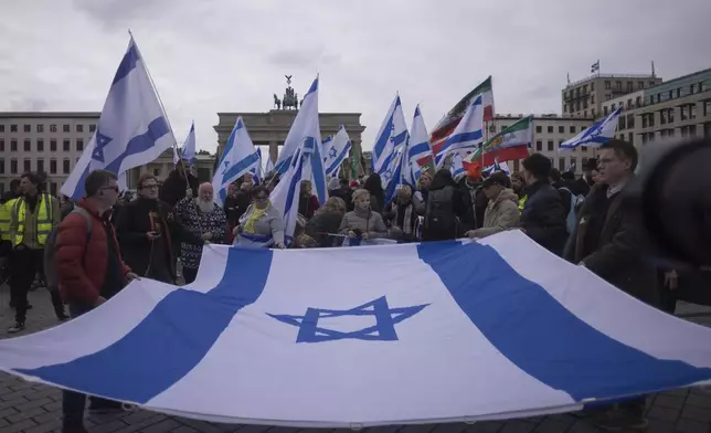 People attend a demonstration in support of Israel to mark the first anniversary of the Hamas attack on Israel, at the Brandenburg Gate in Berlin, Germany, Sunday, Oct. 6, 2024. (AP Photo/Markus Schreiber)