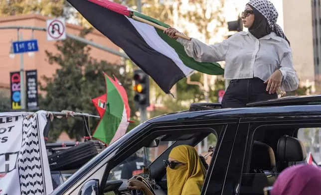 Palestinian supporters drive through downtown Los Angeles on Saturday, Oct. 5, 2024, two days before the anniversary of Hamas-led groups' attack in Israeli territory outside of Gaza on Oct. 7, 2023. (AP Photo/Damian Dovarganes)