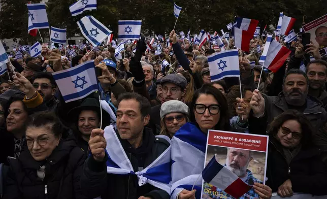 People attend a demonstration in support of Israel to mark the first anniversary of the Hamas attack on Israel, in Paris, Sunday, Oct. 6, 2024. (AP Photo/Louise Delmotte)