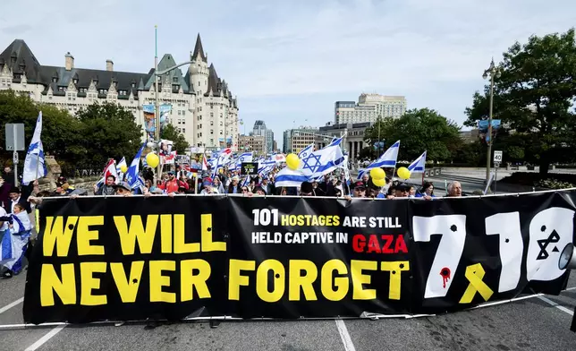 Pro-Israel protesters march towards Parliament Hill from Ottawa City Hall during a ceremony in Ottawa, Canada, on Sunday, Oct. 6, 2024. (Spencer Colby/The Canadian Press via AP)