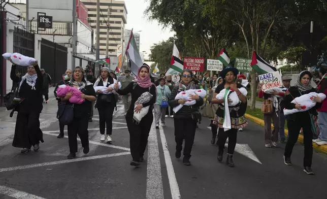 Pro-Palestinian demonstrators march in support of the Palestinians, in Lima, Peru, Monday, Oct. 7, 2024. (AP Photo/Guadalupe Pardo)