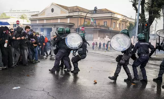 Italian Police and demonstrators clash during a march in support of the Palestinian people in Rome, Saturday, Oct. 5, 2024, two days before the anniversary of Hamas-led groups attack in Israeli territory outside of Gaza on Oct. 7, 2023. (AP Photo/Andrew Medichini)