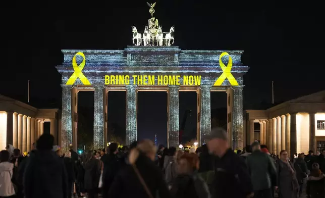 The Brandenburg Gate is illuminated in solidarity with Israel, marking the first anniversary of the Hamas spearheaded attacks on Israel, in Berlin, Germany, Monday, Oct. 7, 2024. (AP Photo/Markus Schreiber)