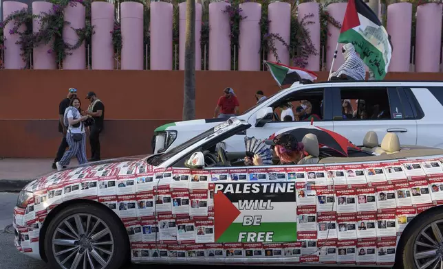 Palestinian supporters drive through downtown Los Angeles on Saturday, Oct. 5, 2024, two days before the anniversary of Hamas-led groups' attack in Israeli territory outside of Gaza on Oct. 7, 2023. (AP Photo/Damian Dovarganes)