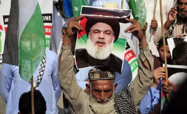 Supporters of the Pakistani religious group Jamaat-e-Islami take part in a rally against Israeli airstrikes and show solidarity with Palestinian people living in Gaza and Lebanon, in Peshawar, Pakistan, Monday, Oct. 7, 2024. (AP Photo/Mohammad Sajjad)