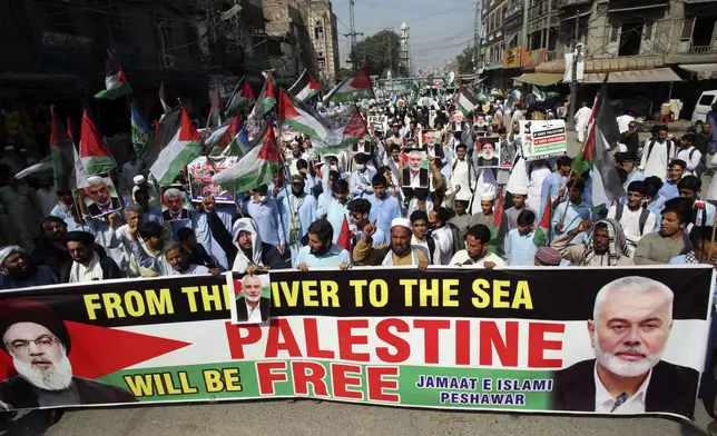 Supporters of the Pakistani religious group Jamaat-e-Islami take part in a rally against Israeli airstrikes and show solidarity with Palestinian people living in Gaza and Lebanon, in Peshawar, Pakistan, Monday, Oct. 7, 2024. (AP Photo/Mohammad Sajjad)