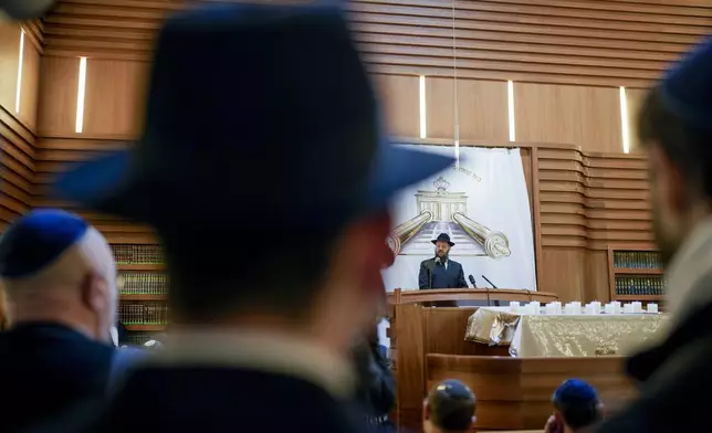 Rabi Yehuda Teichtal speaks at the synagogue of the Chabad community in Berlin, Germany, Monday, Oct. 7, 2024. (AP Photo/Markus Schreiber)