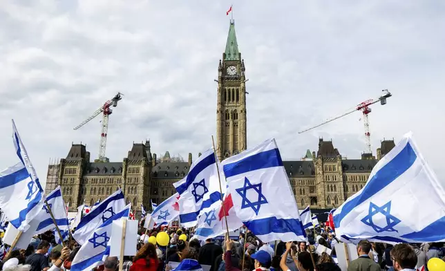 Pro-Israel protesters take part in a commemorative ceremony on Parliament Hill in Ottawa, Canada on Sunday, Oct. 6, 2024. (Spencer Colby/The Canadian Press via AP)