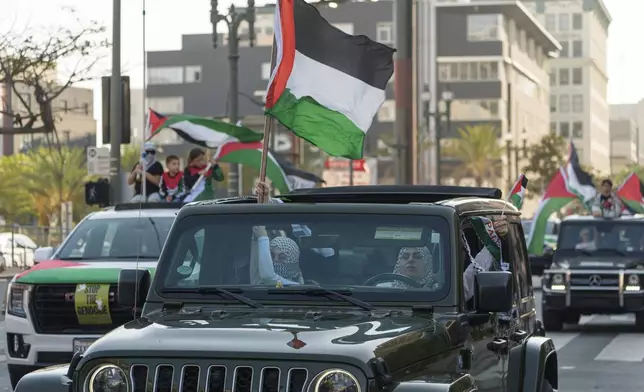 Palestinian supporters drive through downtown Los Angeles on Saturday, Oct. 5, 2024, two days before the anniversary of Hamas-led groups' attack in Israeli territory outside of Gaza on Oct. 7, 2023. (AP Photo/Damian Dovarganes)