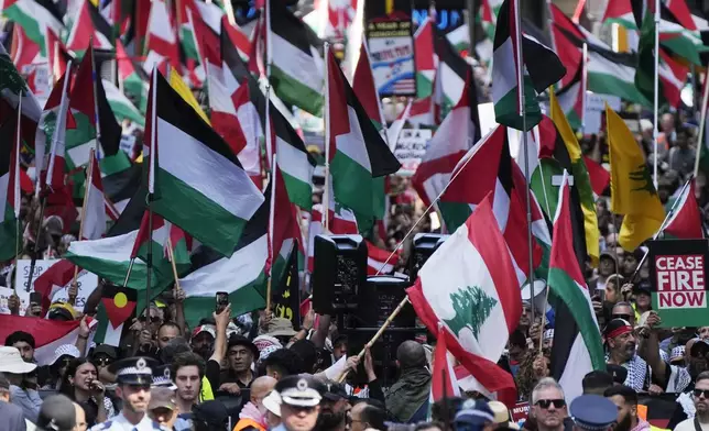 People march on the street as Pro-Palestinian supporters rally in Sydney, Sunday, Oct. 6, 2024. (AP Photo/Rick Rycroft)