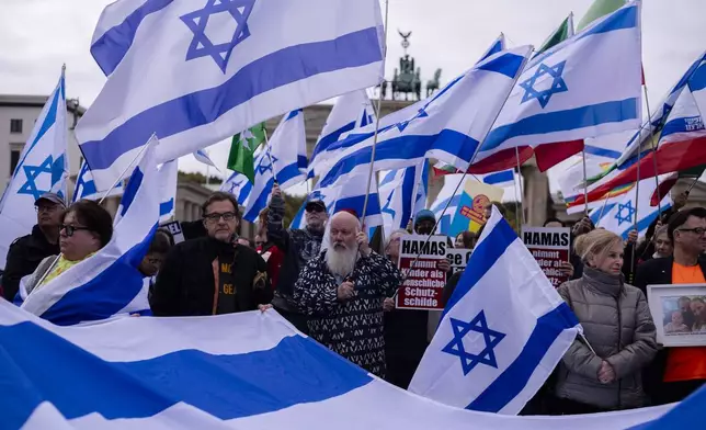 People attend a demonstration in support of Israel to mark the first anniversary of the Hamas attack on Israel, at the Brandenburg Gate in Berlin, Germany, Sunday, Oct. 6, 2024. (AP Photo/Markus Schreiber)