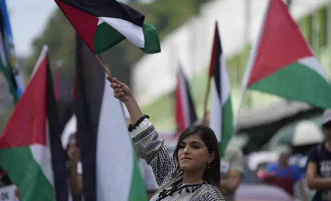 People march to show support for the Palestinians in downtown Guatemala City, Sunday, Oct. 6, 2024, amid Israel's wars on Hamas and Hezbollah. (AP Photo/Moises Castillo)