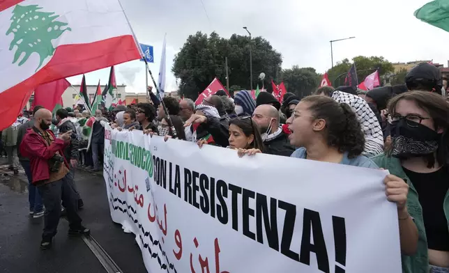 People attend at a protest in Rome, Saturday, Oct. 5, 2024. Pro-palestinians people take to the street in an unauthorised march in the centre of Rome two days ahead of the first anniversary of the Oct. 7. (AP Photo/Andrew Medichini)