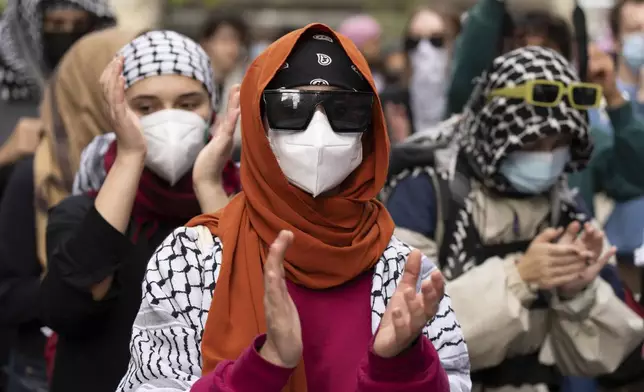 Attendees march during a pro-Palestinian demonstration on the anniversary of a Hamas attack on Israel that triggered the ongoing war in Gaza, in Montreal, Canada, Monday, Oct. 7, 2024. (Christinne Muschi/The Canadian Press via AP)