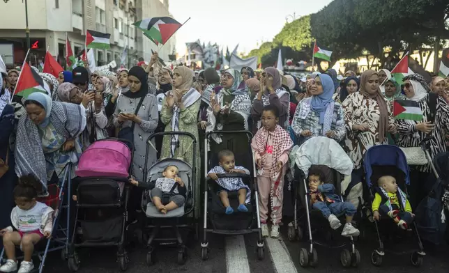 Moroccan women wave flags and chant slogans in support of Gaza and Lebanon during a protest in Rabat, Morocco, Sunday, Oct. 6, 2024 (AP Photo/Mosa'ab Elshamy)