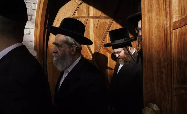 Members of the Jewish community leave the synagogue to listen to Britain's Foreign Secretary David Lammy on the occasion of his visit at South Tottenham United Synagogue in London Monday, Oct. 7, 2024. (Dan Kitwood/Pool Photo via AP)