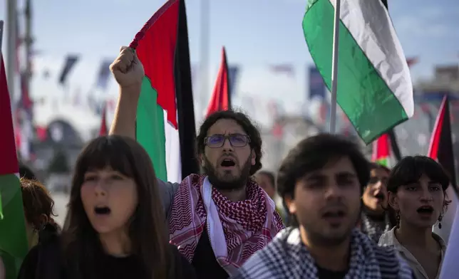 Demonstrators hold Palestinian flags and chant slogans during a pro Palestinian protest in Istanbul, Turkey, Saturday, Oct. 5, 2024. (AP Photo/Khalil Hamra)