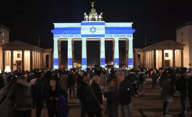 The Brandenburg Gate is illuminated in solidarity with Israel, marking the first anniversary of the Hamas spearheaded attacks on Israel, in Berlin, Germany, Monday, Oct. 7, 2024. (AP Photo/Markus Schreiber)