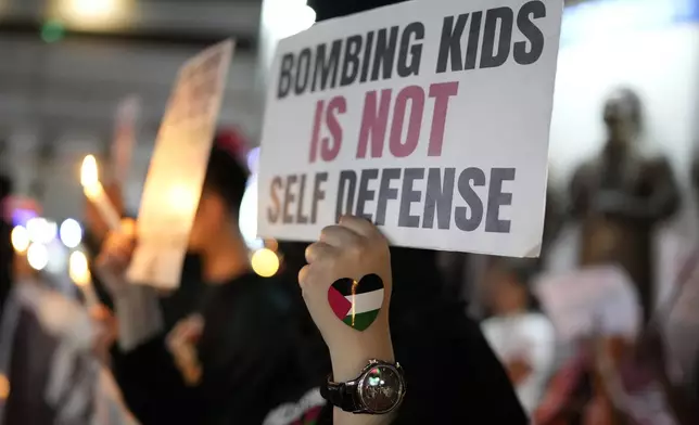 Activists hold signs during a pro-Palestinian rally held to mark the one-year anniversary of the Hamas attack on Israel on Monday Oct. 7, 2024, in Quezon City, Philippines. (AP Photo/Aaron Favila)