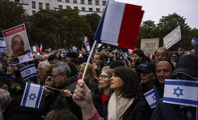 People attend a demonstration in support of Israel to mark the first anniversary of the Hamas attack on Israel, in Paris, Sunday, Oct. 6, 2024.(AP Photo/Louise Delmotte)