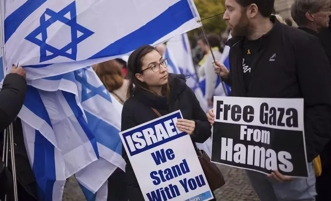 People attend a demonstration in support of Israel to mark the first anniversary of the Hamas attack on Israel, at the Brandenburg Gate in Berlin, Germany, Sunday, Oct. 6, 2024. (AP Photo/Markus Schreiber)