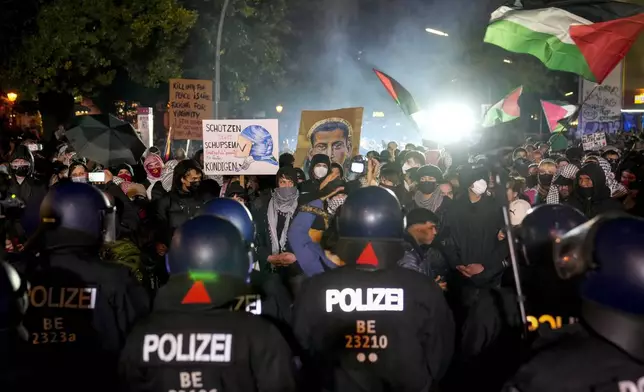 EDS NOTE: OBSCENITY - People take part in a pro-Palestinian rally in Berlin, Monday, Oct. 7, 2024. (AP Photo/Ebrahim Noroozi)