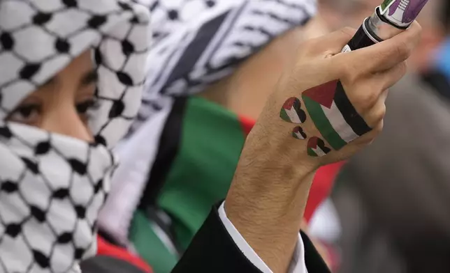 Women attend at a protest in Rome, Saturday, Oct. 5, 2024. Pro-palestinians people take to the street in an unauthorised march in the centre of Rome two days ahead of the first anniversary of the Oct. 7. (AP Photo/Andrew Medichini)