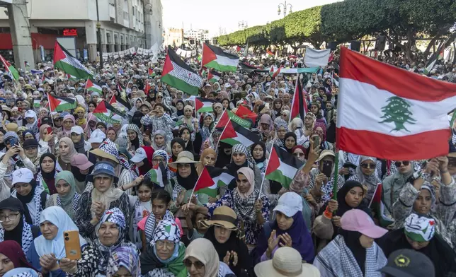 Women wave flags and chant slogans in support of Gaza and Lebanon during a protest in Rabat, Morocco, Sunday, Oct. 6, 2024 (AP Photo/Mosa'ab Elshamy)