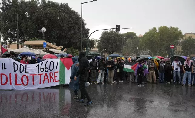 People stand during a protest in Rome, Saturday, Oct. 5, 2024. Pro-palestinians people take to the street in an unauthorised march in the centre of Rome two days ahead of the first anniversary of the Oct. 7. (AP Photo/Andrew Medichini)