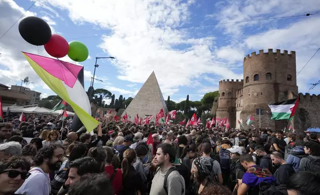 People attend at a protest in Rome, Saturday, Oct. 5, 2024. Pro-palestinians people take to the street in an unauthorised march in the centre of Rome two days ahead of the first anniversary of the Oct. 7. (AP Photo/Andrew Medichini)