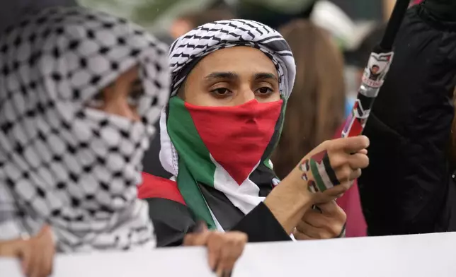 Women attend at a protest in Rome, Saturday, Oct. 5, 2024. Pro-palestinians people take to the street in an unauthorised march in the centre of Rome two days ahead of the first anniversary of the Oct. 7. (AP Photo/Andrew Medichini)