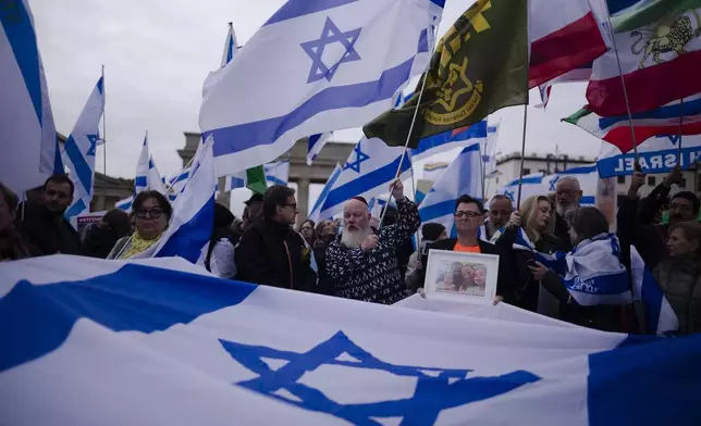 People attend a demonstration in support of Israel to mark the first anniversary of the Hamas attack on Israel, at the Brandenburg Gate in Berlin, Germany, Sunday, Oct. 6, 2024. (AP Photo/Markus Schreiber)