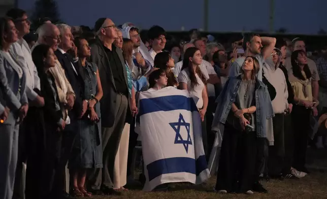 Members of the Jewish community gather at a park in Sydney, Australia, on Monday, Oct. 7, 2024, as mourners marked the anniversary of the Oct. 7, 2023, Hamas attack. (AP Photo/Rick Rycroft)