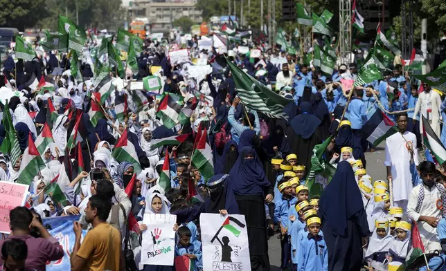 School children take part in a rally organized by Pakistan Markazi Muslim League party, to protest against Israeli airstrikes and to show solidarity with Palestinian people living in Gaza and Lebanon, in Karachi, Pakistan, Monday, Oct. 7, 2024. (AP Photo/Fareed Khan)