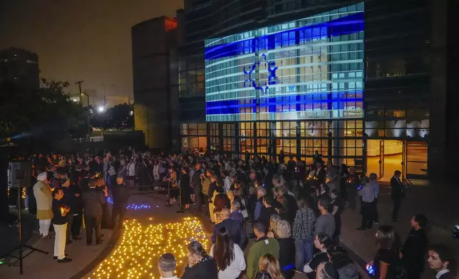 Members of the Los Angeles Jewish community and interfaith leaders hold a candle-lighting ceremony marking the exact moment of the first anniversary since Hamas spearheaded attacks on Israel on Oct. 7, 2023, at The Museum of Tolerance in Los Angeles on Sunday, Oct. 6, 2024. (AP Photo/Damian Dovarganes)