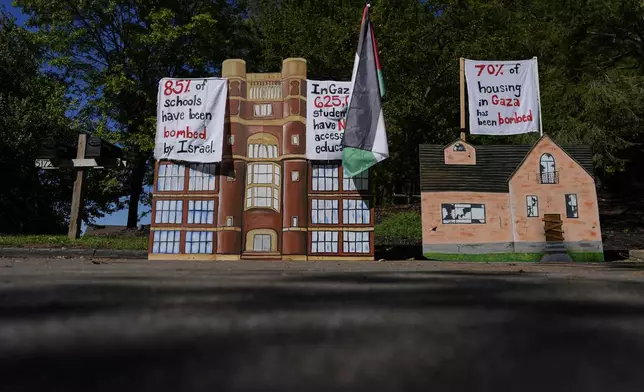 A display describing the bombing of Gaza is seen near the driveway of Ohio Democratic Rep. Greg Landsman's Cincinnati residence, Monday, Oct. 7, 2024. (AP Photo/Carolyn Kaster)