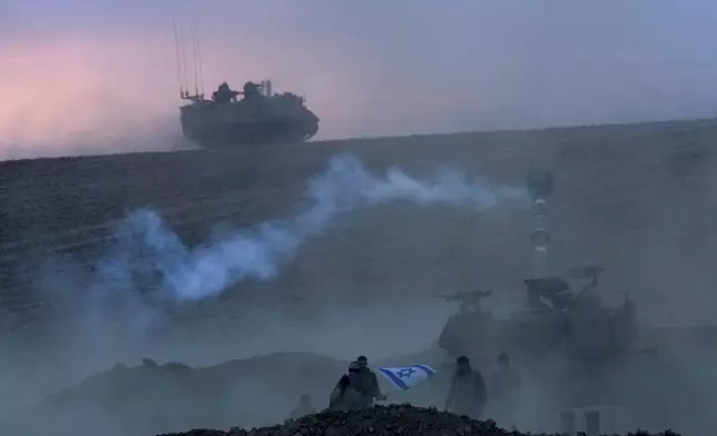 An Israeli mobile artillery unit fires a shell from southern Israel toward the Gaza Strip, in a position near the Israel-Gaza border, Israel, Saturday, Oct. 14, 2023. (AP Photo/Maya Alerruzzo)