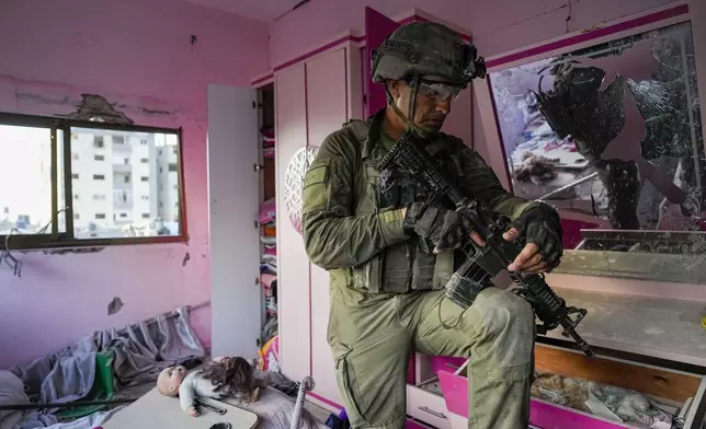 Israeli Lt. Col. Ido Ben Anat stands in an apartment during a ground operation in the Gaza Strip, Wednesday, Nov. 8, 2023. (AP Photo/Ohad Zwigenberg)