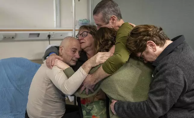 Hostage Luis Har, left, is hugged by relatives after being rescued from captivity in the Gaza Strip, at the Sheba Medical Center in Ramat Gan, Israel, Monday, Feb. 12, 2024. (Israeli Army via AP)