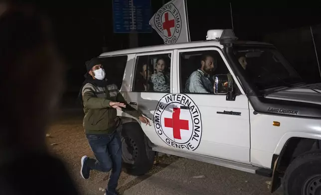 A Red Cross vehicle carrying Israeli hostages drives by at the Gaza Strip crossing into Egypt in Rafah on Saturday, Nov. 25, 2023. (AP Photo/Fatima Shbair)