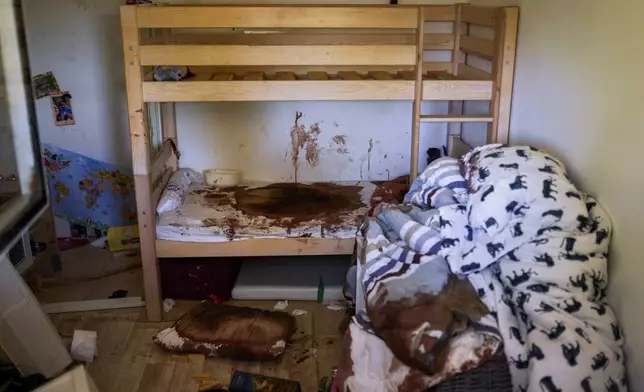 Blood is splattered in a child's room following a massive Hamas militant attack in Kibbutz Nir Oz, Israel, Thursday, Oct. 19, 2023. (AP Photo/Francisco Seco)