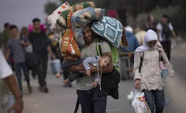 Palestinians flee to the southern Gaza Strip on Salah al-Din Street in Bureij, Gaza Strip, Saturday, Nov. 11, 2023. (AP Photo/Fatima Shbair)