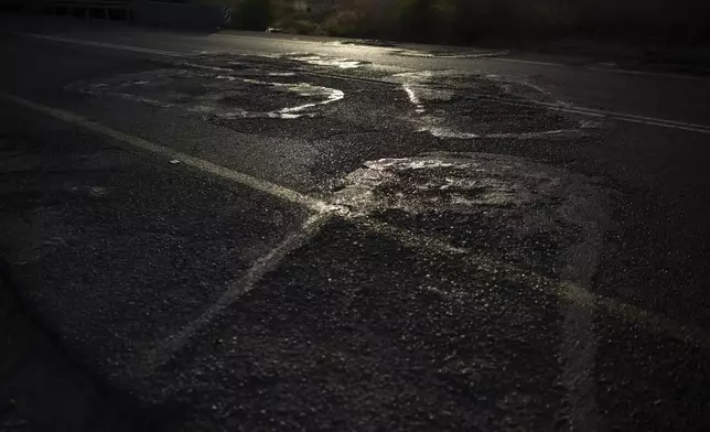 The outlines of burned cars still mar the tarmac of Road 232 where people attempted to flee the Nova music festival during the Hamas attack on Oct. 7, 2023, near Kibbutz Reim, southern Israel, Thursday, Sept. 12, 2024. (AP Photo/Leo Correa)