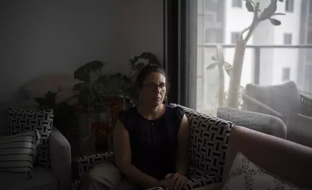 Liat Atzili talks about the Hamas attack on Oct. 7, 2023, on Kibbutz Nir Oz during an interview at her temporary home in Kiryat Gat, Israel, Sunday, Sept. 22, 2024. Atzili was kidnapped and held hostage for 54 days in Gaza. Her husband, Aviv, was killed and his body was taken to Gaza. (AP Photo/Leo Correa)