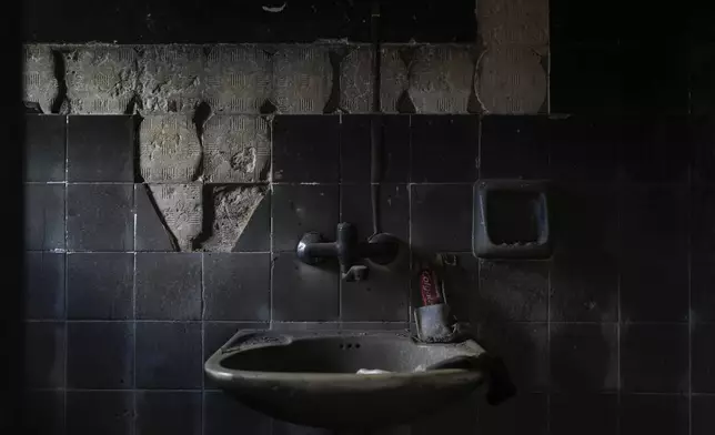 A sink in a house burnt by Hamas militants remains singed and blackened a year after the deadly Oct. 7 attack on Kibbutz Kfar Aza in southern Israel, Monday, Sept. 16, 2024. (AP Photo/Ohad Zwigenberg)