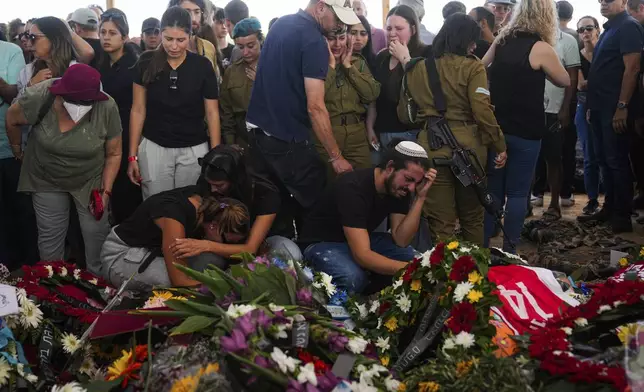 FILE- Mourners attend the funeral of the Kotz family in Gan Yavne, Israel, on Oct. 17, 2023. The Israeli family of five was killed by Hamas militants on Oct. 7 at their house in Kibbutz Kfar Aza near the border with the Gaza Strip. (AP Photo/Ohad Zwigenberg, File)