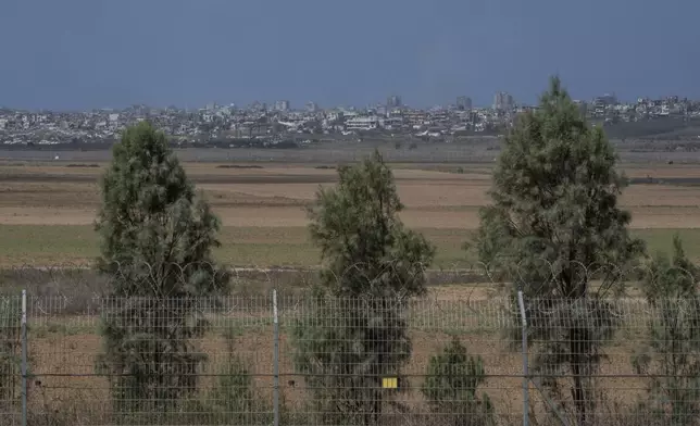 Destroyed buildings in the Gaza Strip are visible from Kibbutz Kfar Aza, southern Israel, Monday, Sept. 16, 2024. (AP Photo/Ohad Zwigenberg)