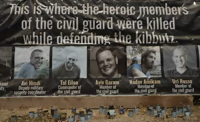 Memorial plaque commemorating the men from the civilian defense squad of Kfar Aza who were killed by Hamas militants in the Oct. 7 attack on the kibbutz in southern Israel, Sunday, Aug. 18, 2024. (AP Photo/Ohad Zwigenberg)